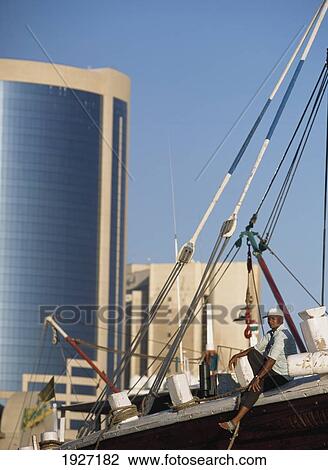 Man Sitting On The Bow Of His Dhow View Large Photo Image Stock Image - Man Sitting On The Bow Of His Dhow. Fotosearch