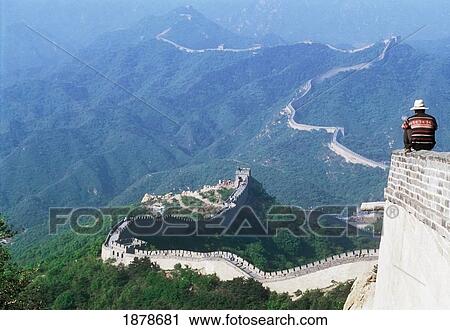 Stock Image - Man Sitting On Wall Of Great Wall Of China. Fotosearch