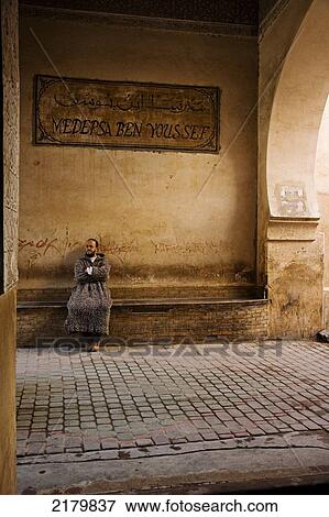 Man sitting outside Medersa Ben Youseff; Marrakesh, Morocco View Large Photo Image Stock Photo - Man sitting outside Medersa Ben Youseff; Marrakesh, Morocco. Fotosearch