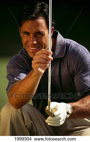 Man Sizes Up Putt With Golf Club View Large Photo Image Picture - Man Sizes Up Putt With Golf Club. Fotosearch