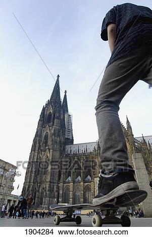 Man Skateboarding Near Cologne Cathedral (Kolner Dom), Low Angle View, Cologne, Germany View Large Photo Image Picture - Man Skateboarding Near Cologne Cathedral (Kolner Dom), Low Angle View, Cologne, Germany. Fotosearch