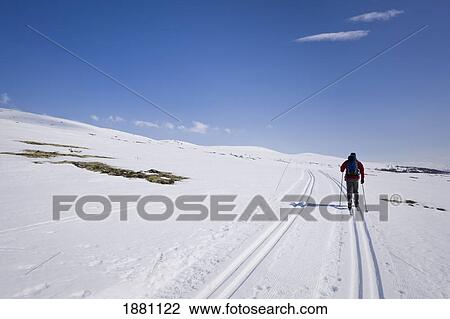 Stock Image - Man Skiing Up Into The Hills Of Rondane National Park; Rondane, Norway. Fotosearch
