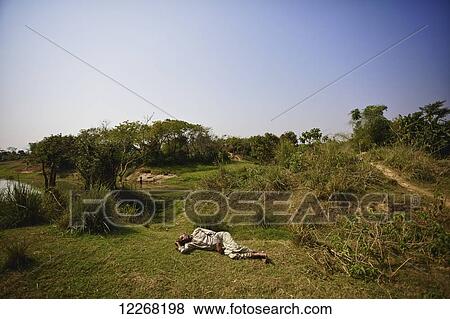 Man sleeping in field; Sunamganj, Bangladesh View Large Photo Image Stock Photo - Man sleeping in field; Sunamganj, Bangladesh. Fotosearch