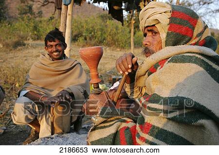 Stock Image - Man Smoking Hookah Alwar District Rajasthan India. Fotosearch