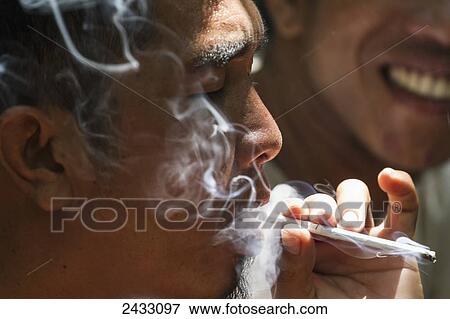 Man smoking, Pondok Tanggui, Tanjung Puting National Park, Central Kalimantan, Borneo, Indonesia View Large Photo Image Stock Photo - Man smoking, Pondok Tanggui, Tanjung Puting National Park, Central Kalimantan, Borneo, Indonesia. Fotosearch
