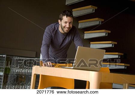 Man Standing At A Laptop, Toronto, Ontario View Large Photo Image Stock Photograph - Man Standing At A Laptop, Toronto, Ontario. Fotosearch