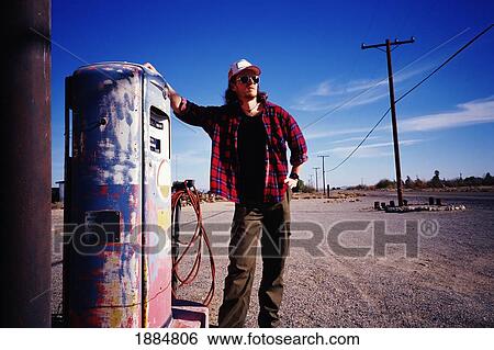 Man Standing Beside Pump At Old Gas Station View Large Photo Image Stock Photograph - Man Standing Beside Pump At Old Gas Station. Fotosearch