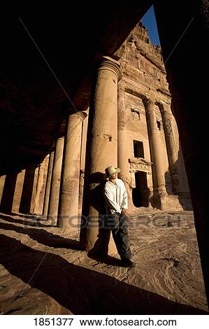 Man Standing By Royal Tomb In Petra View Large Photo Image Stock Photo - Man Standing By Royal Tomb In Petra. Fotosearch