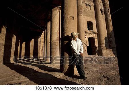 Man Standing By Royal Tomb In Petra View Large Photo Image Stock Photo - Man Standing By Royal Tomb In Petra. Fotosearch