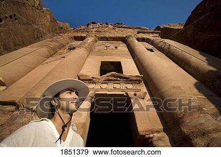 Stock Photo - Man Standing By Royal Tomb In Petra. Fotosearch