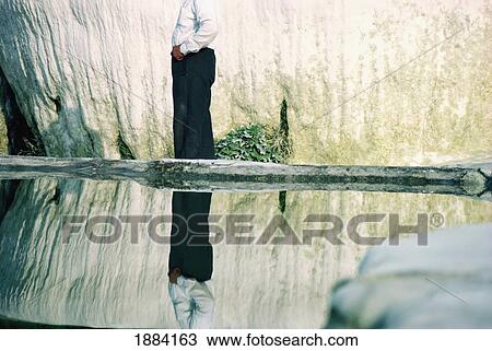 Stock Image - Man Standing By Water Pools In Pamukkale. Fotosearch