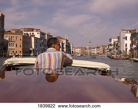 Man Standing In Motorboat; Venice, Italy View Large Photo Image Stock Image - Man Standing In Motorboat; Venice, Italy. Fotosearch