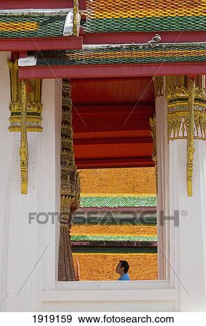 Stock Photo - Man Standing In Thung Sri Muang Temple. Fotosearch
