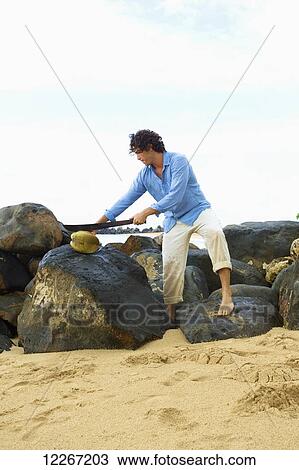 Man standing on boulders on Lydgate Beach; Kauai, Hawaii, United States of America View Large Photo Image Stock Image - Man standing on boulders on Lydgate Beach; Kauai, Hawaii, United States of America. Fotosearch