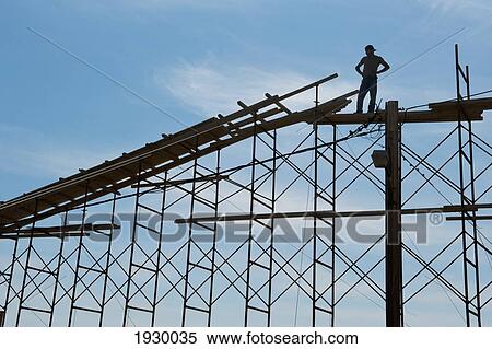 Stock Photography - Man standing on scaffolding; Moni Chrysoskalitissas, Crete, Greece. Fotosearch