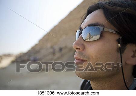 Man Standing With Pyramids In Background; Cairo, Egypt, Africa View Large Photo Image Stock Photograph - Man Standing With Pyramids In Background; Cairo, Egypt, Africa. Fotosearch