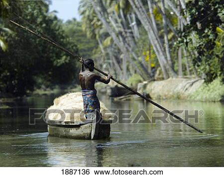 Man Steering Boat Filled With Coconuts In The Backwaters View Large Photo Image Stock Photograph - Man Steering Boat Filled With Coconuts In The Backwaters. Fotosearch