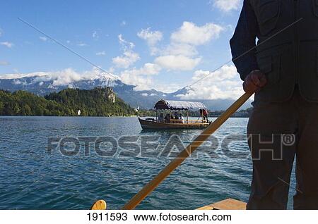 Man Steering Pletna Boat, Lake Bled, Gorenjska Region, Slovenia View Large Photo Image Stock Image - Man Steering Pletna Boat, Lake Bled, Gorenjska Region, Slovenia. Fotosearch