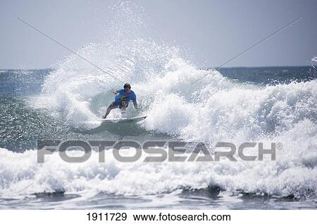 Stock Photo - Man Surfing, Tanzania, East Africa. Fotosearch