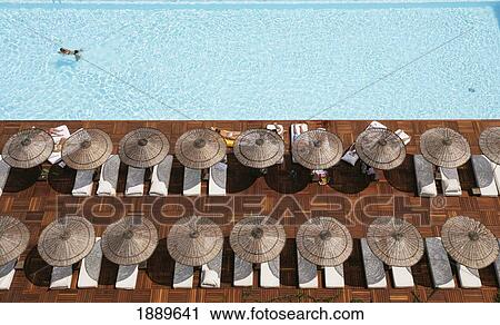 Man Swimming In Pool By Sunloungers, Aerial View View Large Photo Image Stock Image - Man Swimming In Pool By Sunloungers, Aerial View. Fotosearch