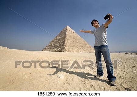 Man Taking A Picture Of Himself With Pyramid In Background View Large Photo Image Stock Image - Man Taking A Picture Of Himself With Pyramid In Background. Fotosearch