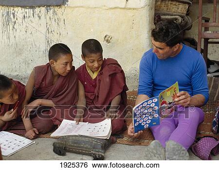 Stock Photograph - Man Teaching Young Monks English. Fotosearch
