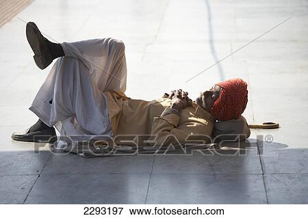 Man waiting for a train in Agra Rajasthan India View Large Photo Image Stock Photo - Man waiting for a train in Agra Rajasthan India. Fotosearch