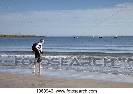 Man Walking Along Beach, Northumberland, England View Large Photo Image Stock Image - Man Walking Along Beach, Northumberland, England. Fotosearch