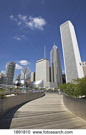 Stock Image - Man Walking Bp Amoco Bridge, With City Skyline In Background. Fotosearch