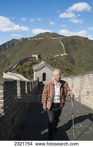 Picture - Man walking in Mutianyu section of Great Wall of China; Beijing, China. Fotosearch