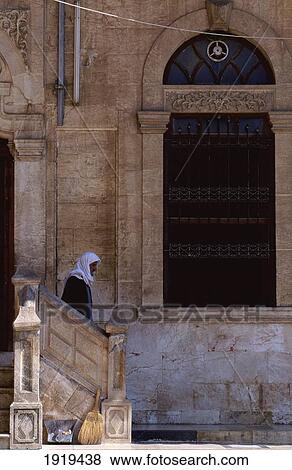 Stock Photo - Man Walking Out Of Building. Fotosearch