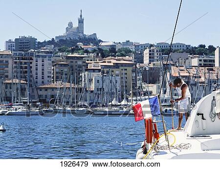 Stock Photo - Man Washing Down Deck Of Boat. Fotosearch