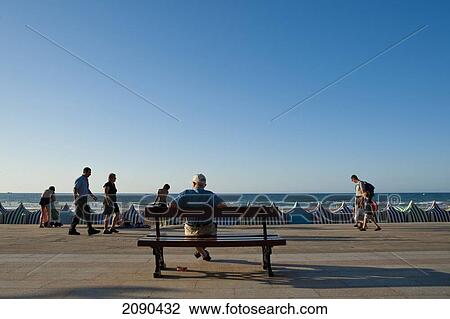 Man Watching People Passing By, Zarautz, Basque Country, Spain View Large Photo Image Stock Image - Man Watching People Passing By, Zarautz, Basque Country, Spain. Fotosearch
