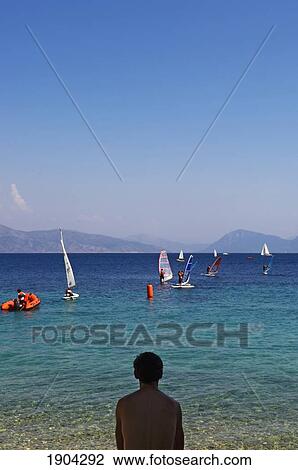 Man Watching People Windsurfing, Rear View, Lefkas, Ionian Islands, Greece View Large Photo Image Stock Image - Man Watching People Windsurfing, Rear View, Lefkas, Ionian Islands, Greece. Fotosearch