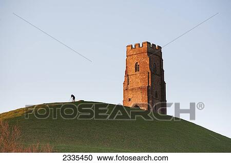 Man Watching Sky With A Telescope Near Tower; Glastonbury, Somerset, England View Large Photo Image Stock Image - Man Watching Sky With A Telescope Near Tower; Glastonbury, Somerset, England. Fotosearch