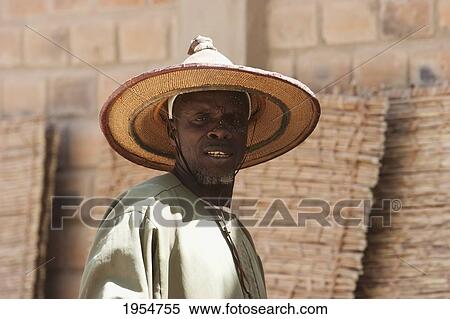 Stock Photography - Man wearing a Fulani Straw Hat, Monday Market, Djenne, Mali. Fotosearch