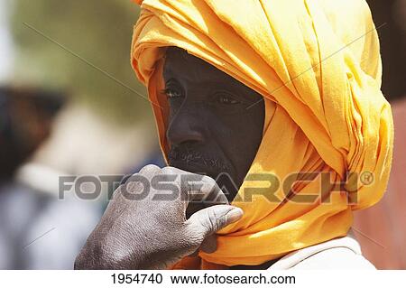 Man wearing a turban at the Monday Market in Djenne, Mali View Large Photo Image Stock Image - Man wearing a turban at the Monday Market in Djenne, Mali. Fotosearch