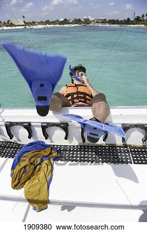 Stock Image - Man Wearing Snorkel Gear Jumping Boat On Mayan Riviera, Yucatan Peninsular, Quintana Roo State, Mexico. Fotosearch