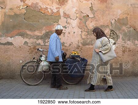 Stock Image - Man With Bicycle Selling Oranges. Fotosearch