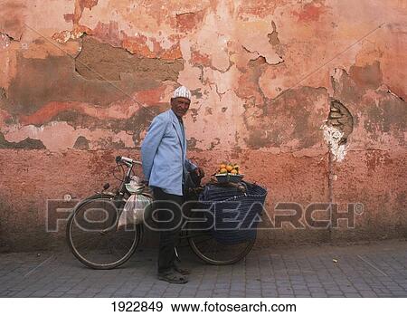 Stock Photo - Man With Bicycle Selling Oranges. Fotosearch