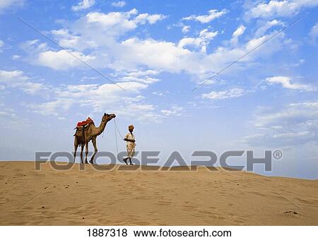 Stock Photo - Man With Camel In Thar Desert. Fotosearch