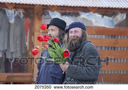 Man With Flowers In Trakai, Lithuania View Large Photo Image Stock Image - Man With Flowers In Trakai, Lithuania. Fotosearch