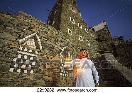 Man with lamp outsude Rijal Alma village; Asir Province, Saudi Arabia View Large Photo Image Stock Image - Man with lamp outsude Rijal Alma village; Asir Province, Saudi Arabia. Fotosearch
