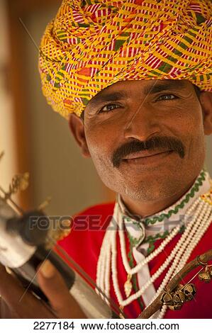 Man with musical instrument in the City Palace; Jaipur, Rajasthan, India View Large Photo Image Picture - Man with musical instrument in the City Palace; Jaipur, Rajasthan, India. Fotosearch