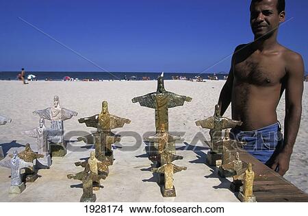 Man With Souvenir Figurines; Copacobana Beach, Rio De Janeiro, Brazil View Large Photo Image Picture - Man With Souvenir Figurines; Copacobana Beach, Rio De Janeiro, Brazil. Fotosearch
