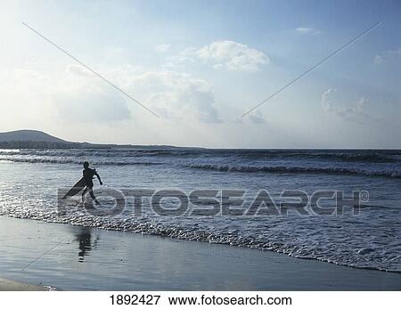 Stock Photo - Man With Surfboard Running On Beach. Fotosearch