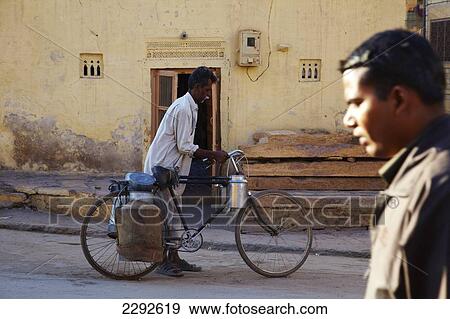 Stock Photo - Man with water containers on his bike Jaisalmer Rajasthan India. Fotosearch