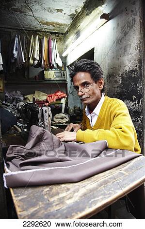 Stock Image - Man working at sewing machine Bikaner Rajasthan India. Fotosearch