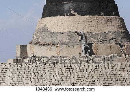 Stock Photograph - Man Working On A Brick Kiln In The Outskirts Of Kabul,, Afghanistan. Fotosearch