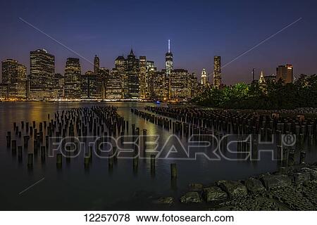 Stock Photo - Manhattan skyline at twilight, Brooklyn Bridge Park, Brooklyn; New York City, New York, United States of America. Fotosearch